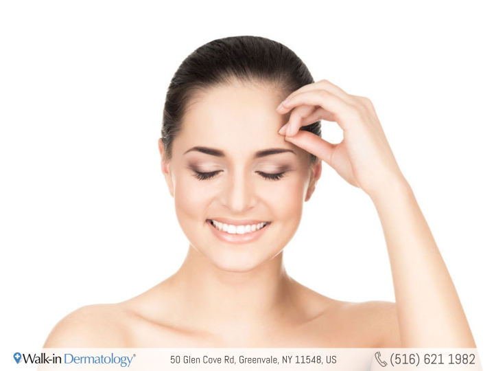 smiling woman touching her forehead