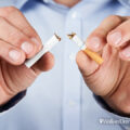 Man snapping a cigarette in half