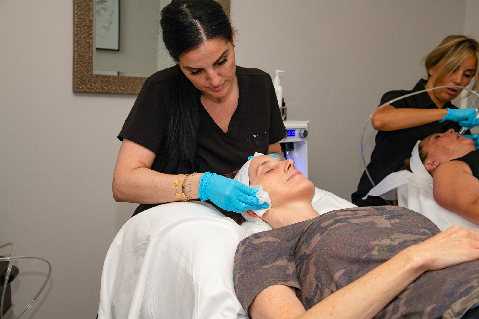 Woman getting treatment on her face by dermatologist at A Night of Beauty