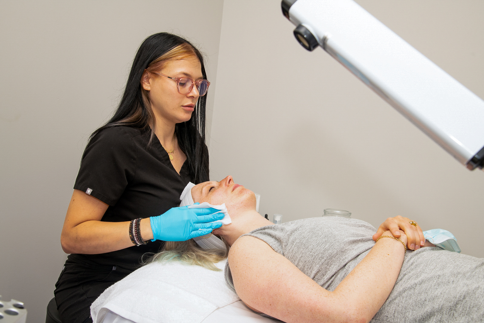 Woman getting her face wiped by dermatologist at A Night of Beauty Event