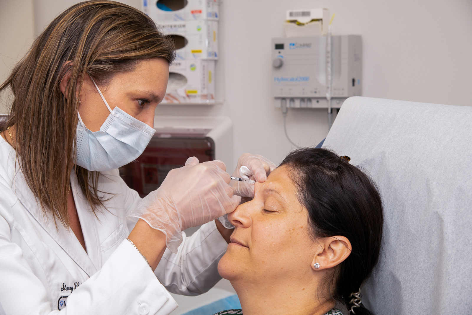Woman getting injection on her forehead by dermatologist at A Night of Beauty Event