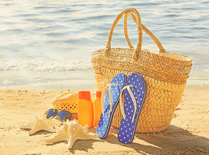 summer vacation beach bag on the sand